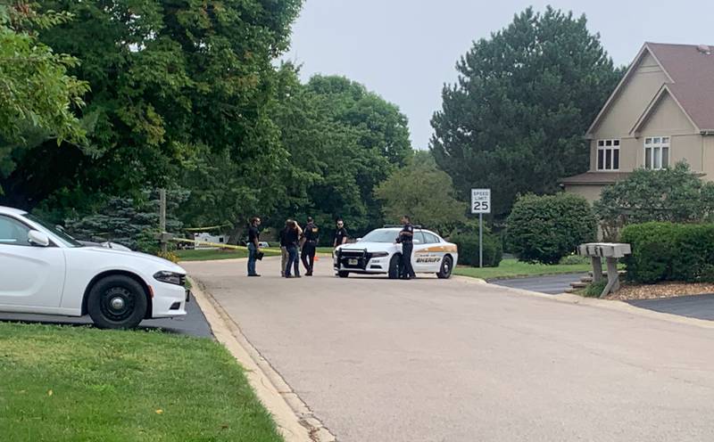 Law enforcement gather Wednesday, Aug. 9, 2023, on Wild Plum Road near Crystal Lake where the McHenry County Sheriff's Office said four people were shot and it was conducting a death investigation.