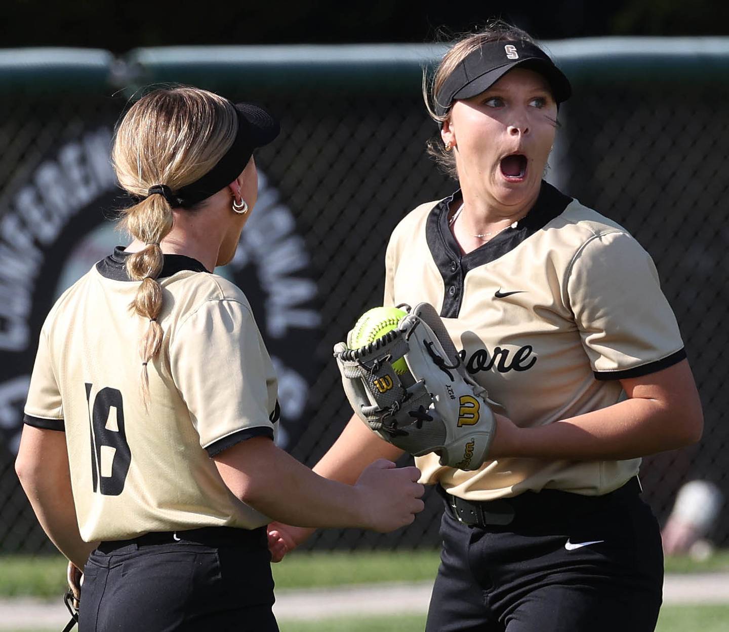 Sycamore's Addison Armstrong (right) can’t believe she made the catch on a popup over the infield during their game Wednesday, May 7, 2025, at Kaneland High School in Maple Park.
