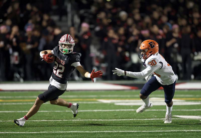 Maine South's Michael Dellumo (22) turns upfield past Evanston's Tyler Stokes (30) Friday October 20, 2023 in Park Ridge.