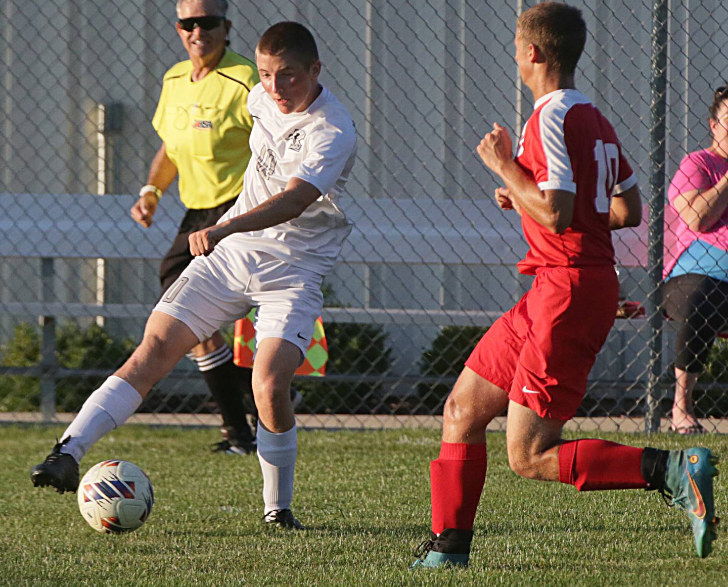 Kaneland's Ethan Nitsche (10) kicks the ball away from Ottawa's Brian Dederich (10) on Wednesday Sept. 7, 2022 in Ottawa.