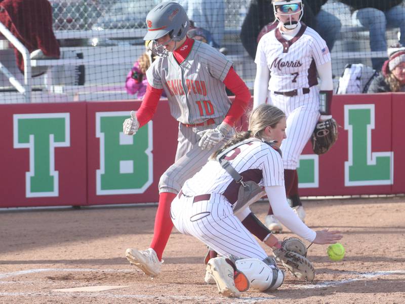 L-P's Kelsey Frederick crosses home plate as the throw comes in late to Morris catcher McKenna Gliwa on Monday, April 7, 2025 at the L-P Athletic Complex in La Salle.