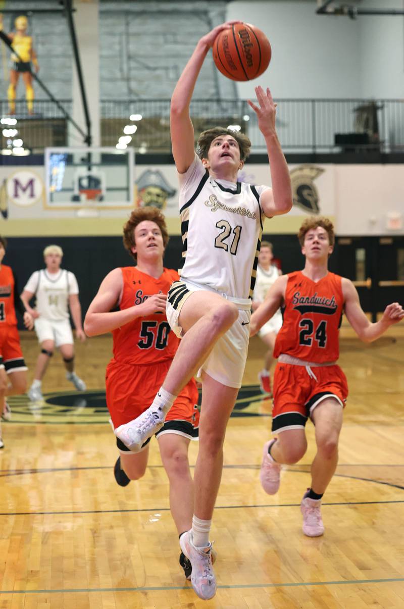 Sycamore's Ben Larry goes up for a dunk in front of Sandwich's Quinn Rome during their game Friday, Nov. 24, 2023, in the Leland G. Strombom Holiday Tournament at Sycamore High School.