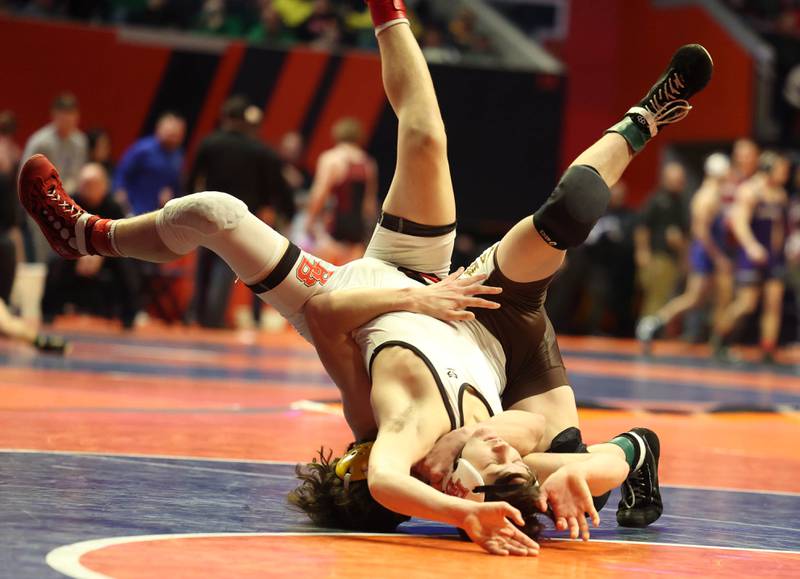 Jacobs’ Dominic Ducato (back) brings down Bradley-Bourbonnais’ Ethan Spacht during the Class 3A 113 pound 3rd place match in the IHSA individual state wrestling finals in the State Farm Center at the University of Illinois in Champaign.