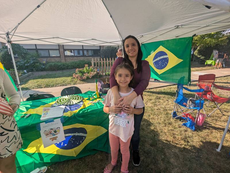 Michelle Ricciardi de Almeida, a new teacher at Huntley Middle School, from Brazil, poses with her daughter, Maria, a student at Jefferson Elementary School, during the annual Multicultural Night in DeKalb on Sept. 13, 2024.