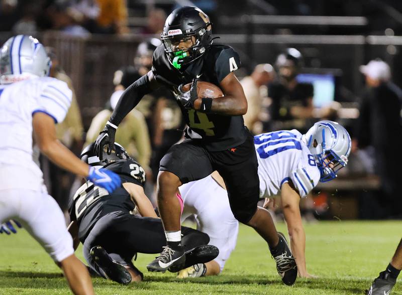 Sycamore's Tyler Curtis breaks through the Woodstock line during their game Friday, Sept. 8, 2023, at Sycamore High School.