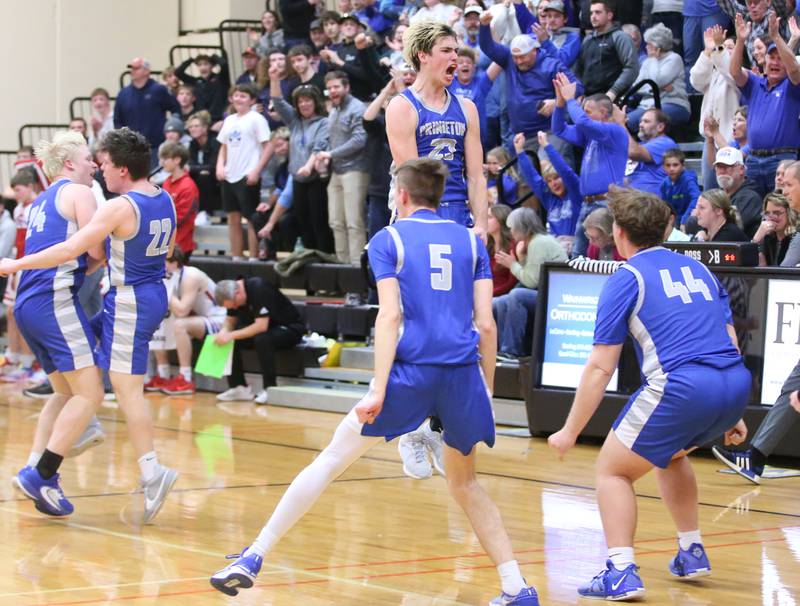 Princeton's Noah LaPort (center) reacts with teammates Landen Koning and Luke Smith  during the Class 2A Regional final game on Friday, Feb. 23, 2024 at Erie-Prophetstown High School.