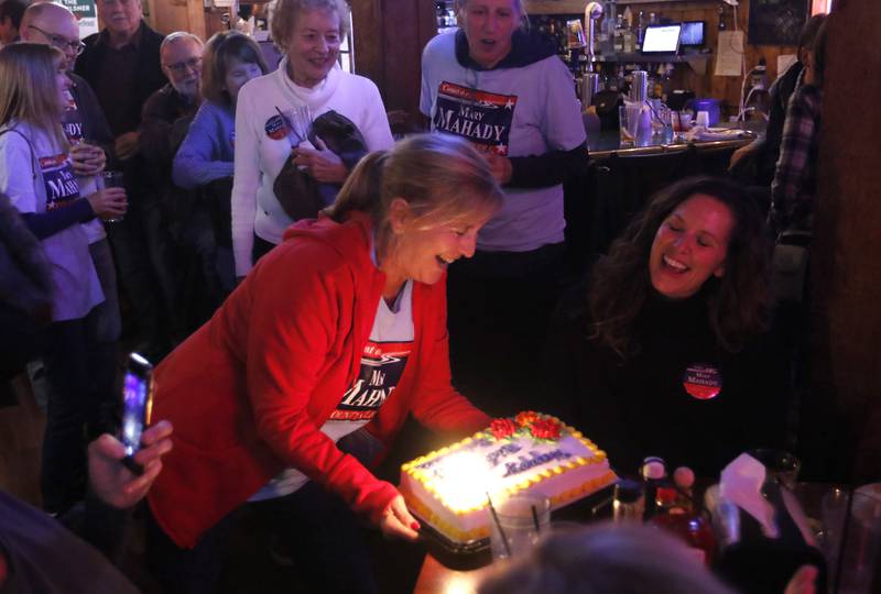 Ilene Sulentic brings a cake to Rebecca Conton, the daughter of McHenry County clerk candidate Mary Mahady, as Conton celebrates her birthday during a Democratic election watch party Tuesday, Nov. 8, 2022, at The Cottage, 6 E. Crystal Lake Ave. in Crystal Lake.