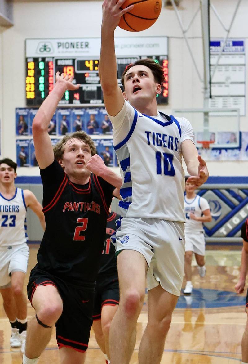 Princeton junior Gavin Lanham takes in a layup over Erie-Prophetstown's Connor Keegan Friday night at Prouty Gym.