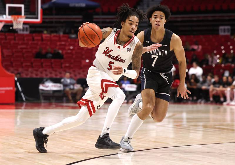 Northern Illinois' Kailon Nicholls drives by Monmouth's Justin Ray during their game Tuesday, Nov. 12, 2024, in the Convocation Center at NIU in DeKalb.