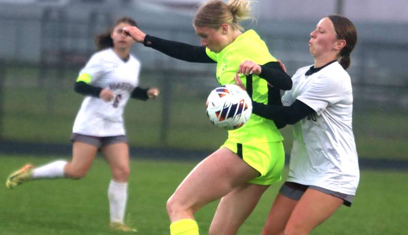 Marengo’s Mackenzie Westwood, right, battles Richmond-Burton’s  Elle Barrettsmith for the ball in IHSA Class 1A Regional Title Game action soccer at Marengo High School in Marengo on Wednesday, May 21, 2025.
