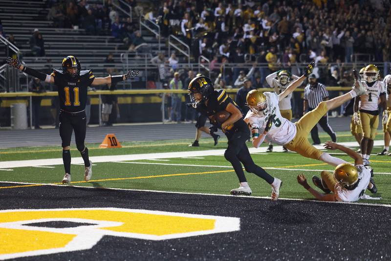 Herscher's Mason Roberts runs in a touchdown past Bishop McNamara defenders during the Tigers 45-28 loss to the Fightin' Irish on Friday, Sept. 5, 2025.