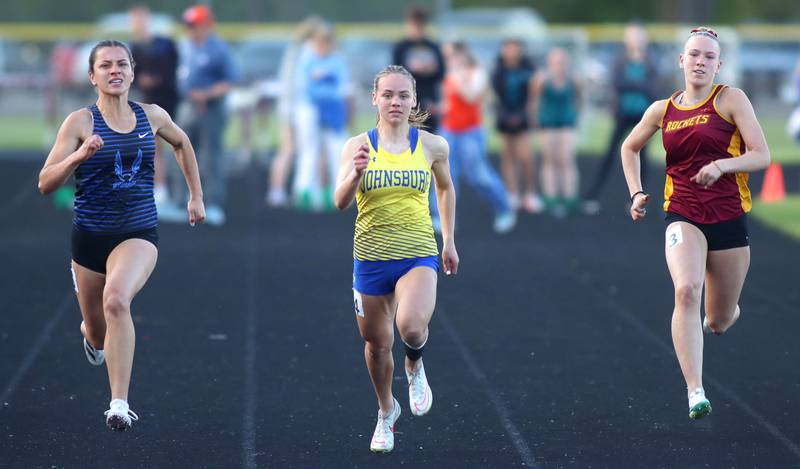From left, Woodstock’s Sophia Mendoza, Johnsburg’s Hope Klosowicz and Richmond-Burton’s Emily Wisniewski run in the 100-meter dash  KRC Conference Track Meet action at Marengo High School in Marengo on Tuesday, May 6, 2025.