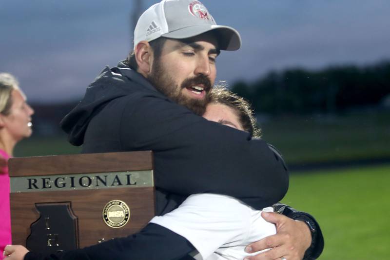 Marengo’s head Coach Sergio Orozco embraces Katie Polizzi after the Indians claimed a 3-2 OT win over Richmond-Burton in IHSA Class 1A Regional Title Game action soccer at Marengo High School in Marengo on Wednesday, May 21, 2025.