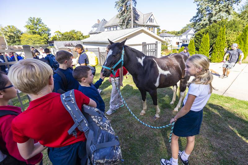 Addessa Hummel, 9, lets schoolmates visit with Missy, Thursday, Oct. 3, 2024, during blessing of the pets at St. Mary’s School in Dixon.