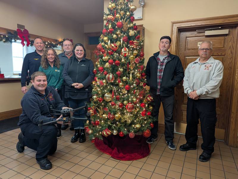 Police Chief Mike Smudzinski (from left), Gina Mudge of JB Contracting, Shawn Mages of Illinois Cement, Lyndsay Bliss of Carus LLC, Police Sgt. Nick Bernal, Fire Chief Jerry Janick, and La Salle Fire Department Engineer/EMT Hunter Thurman (front) gathered on December 10 to celebrate recent drone donations from the aforementioned companies as well as James Brady Farms and John Pohar and Sons.