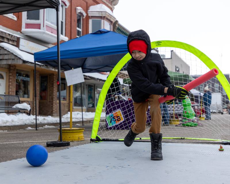 Jofiel Mandujano hits ball with noodle on Saturday, December 6, 2025 on Illinois Avenue in Mendota.