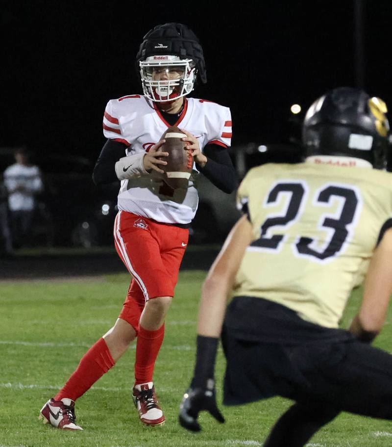 Ottawa's Mark Munson looks for a receiver in the Sycamore secondary during their game Friday, Sept. 27, 2024, at Sycamore High School.