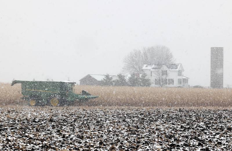 A combine sits idle as the snow falls Tuesday, Nov. 15, 2022, on a farm on McGirr Road just north of Hinckley. Tuesday was the first measurable snowfall in DeKalb County this season.