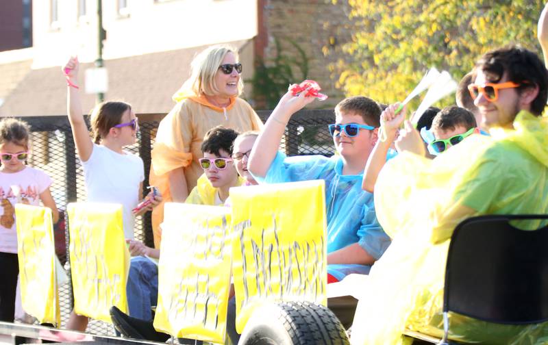Kids ride the Deeds Lights Up Inclusion float during the Hall High School Homecoming parade on Thursday, Sept. 28, 2023 in Spring Valley.