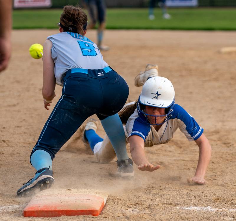 St. Charles North's Ava Goettel (17) dives back to first to avoid the pickoff attempt by Lake Park's Madelyn Fricano (9) during a softball game at St. Charles North High School on Wednesday, May 11, 2022.