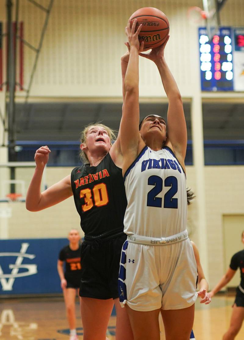 Geneva’s Leah Palmer (22) rebounds the ball against Batavia’s Reagan Sulaver (30) during a basketball game at Geneva High School on Friday, Dec 15, 2023.