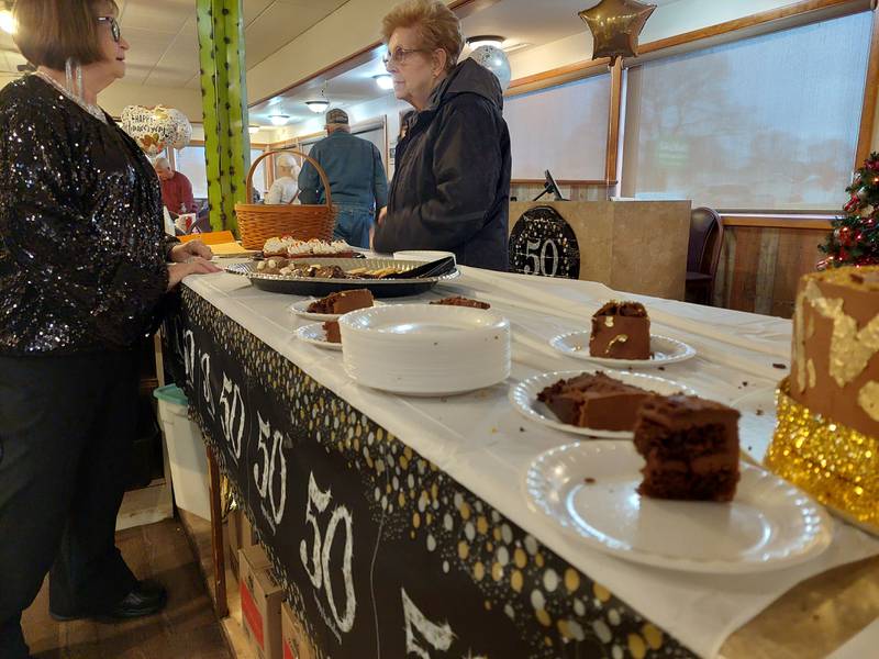 Waitress Sandy Batistini (left) talks to one of New Chalet's customers Friday, Dec. 29, 2023, at the restaurant during a party honoring her for working there for 50 years.