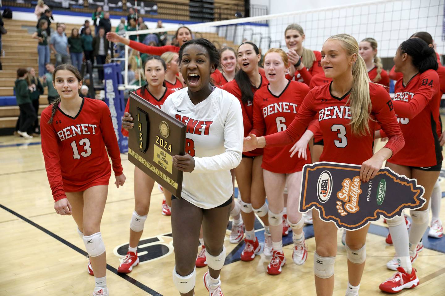 Benet’s Aniya Warren leads her team to the fans after winning the Class 4A St. Charles North Supersectional win on Monday, Nov. 11, 2024 against New Trier.