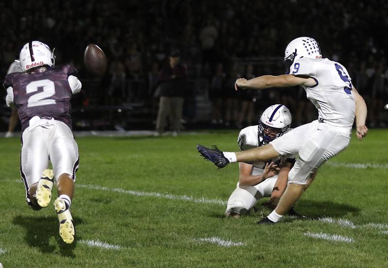 Cary-Grove's Jadon Apgar kicks a field goal as Prairie Ridge's Logan Thennes dives to try an block the ball during a Fox Valley Conference football game on Friday, Sept. 27, 2024, at Prairie Ridge High School.