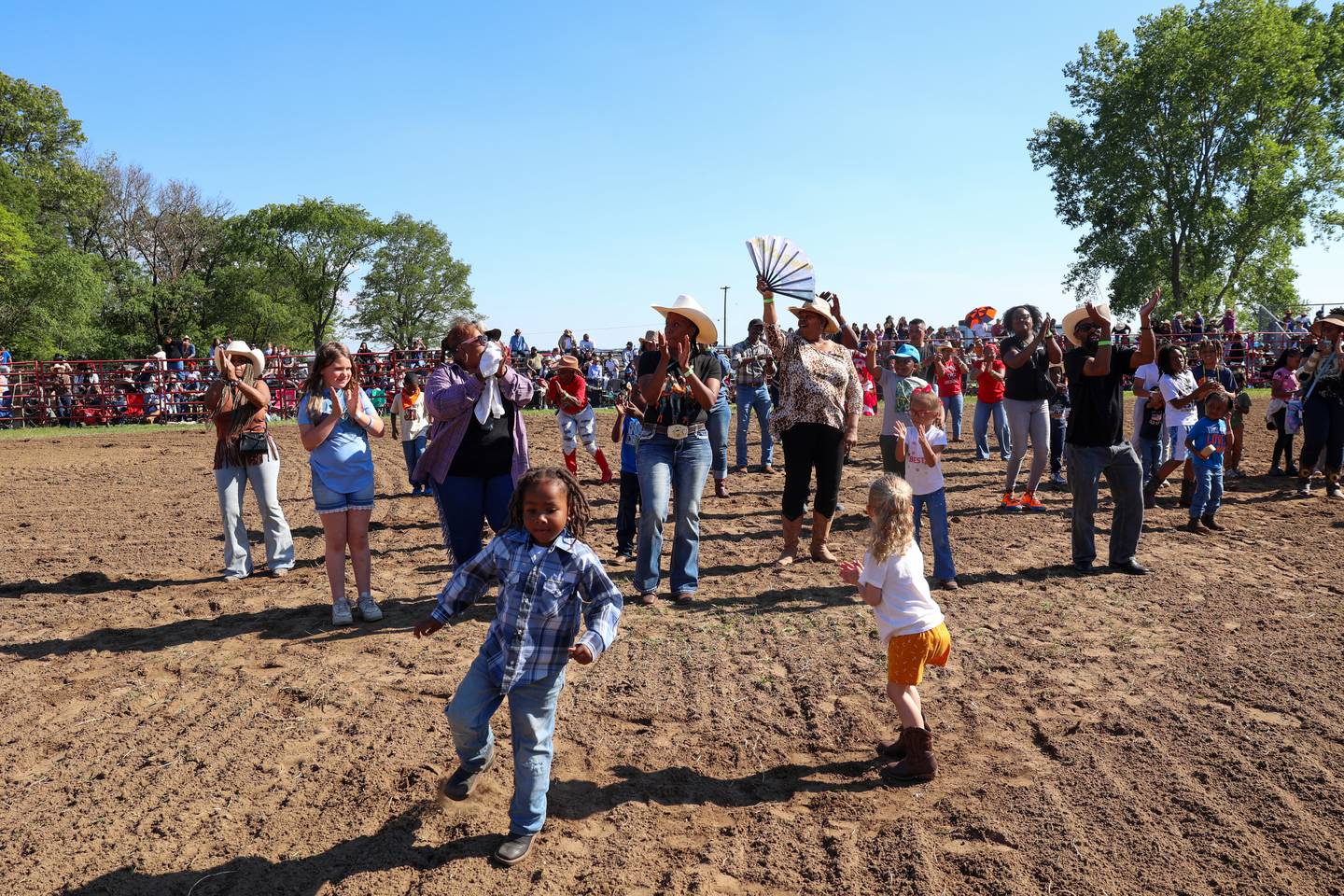 Attendees line dance during a break in competition at the 50th Pembroke Rodeo on Sunday, May 24, 2026.
