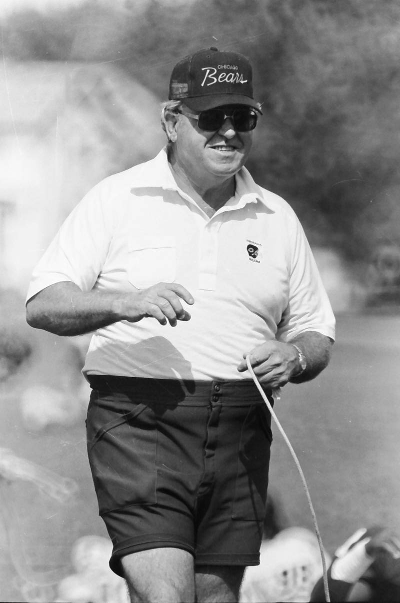 Chicago Bears defensive coordinator Buddy Ryan watches players practice during training camp on Wednesday, June 12, 1985 in Platteville Wis.