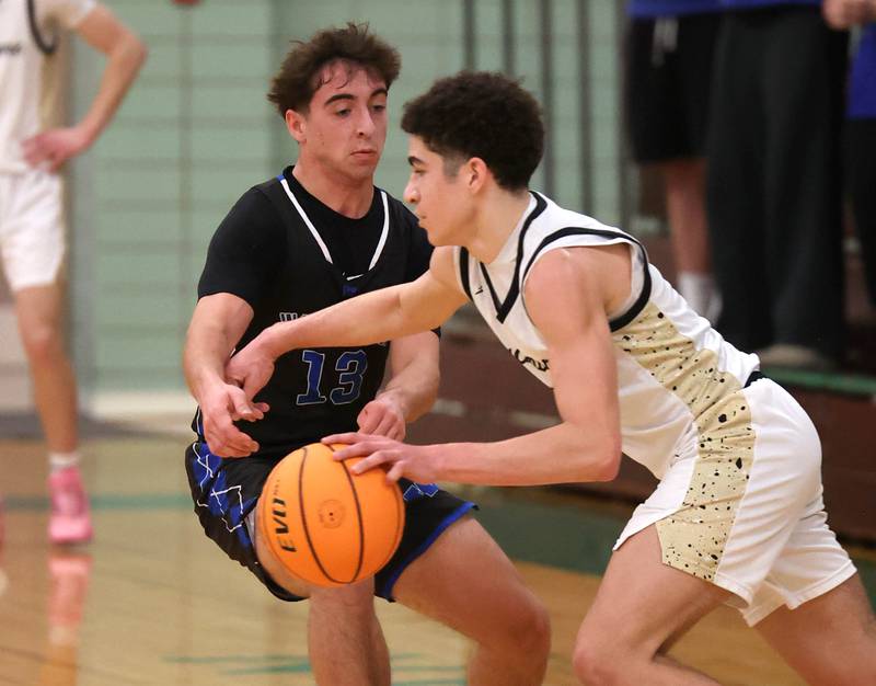 Sycamore's Marcus Johnson works against Woodstock's Ryan Murray Friday, Feb. 27, 2026, during their IHSA Class 3A boys basketball regional championship game at Boylan Catholic High School in Rockford.