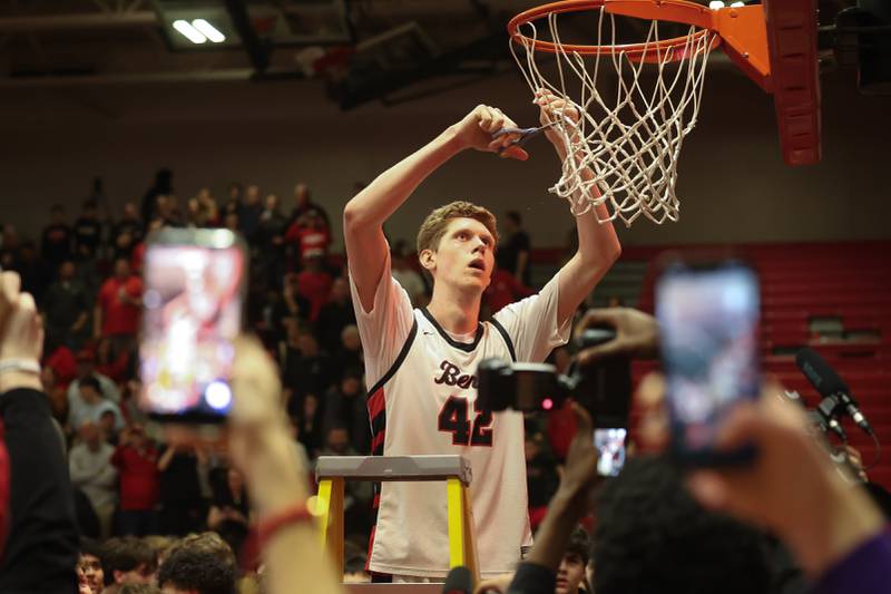 Benet’s Colin Stack cuts off a piece of the net after their section win over Bolingbrook in the Class 4A Bolingbrook Sectional championship game on Friday, March 6, 2026 in Bolingbrook.