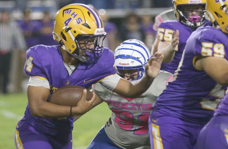 Mendota's Jayden Lesley carries the ball as a Princeton player looks to tackle him on Friday, Oct. 10, 2025 at Bryant Field in Princeton.