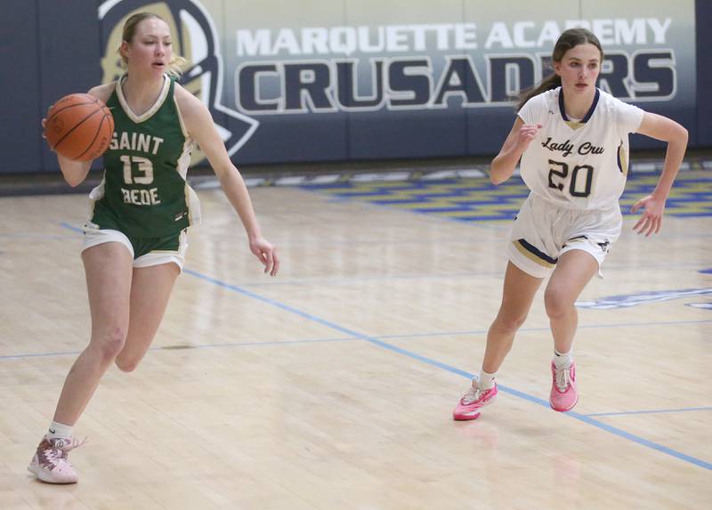 St. Bede's Ashlyn Ehm dribbles down the baseline while Marquette's Kaitlyn Davis rushes down the court on Monday, Nov. 27, 2023 in Bader Gym at Marquette High School.