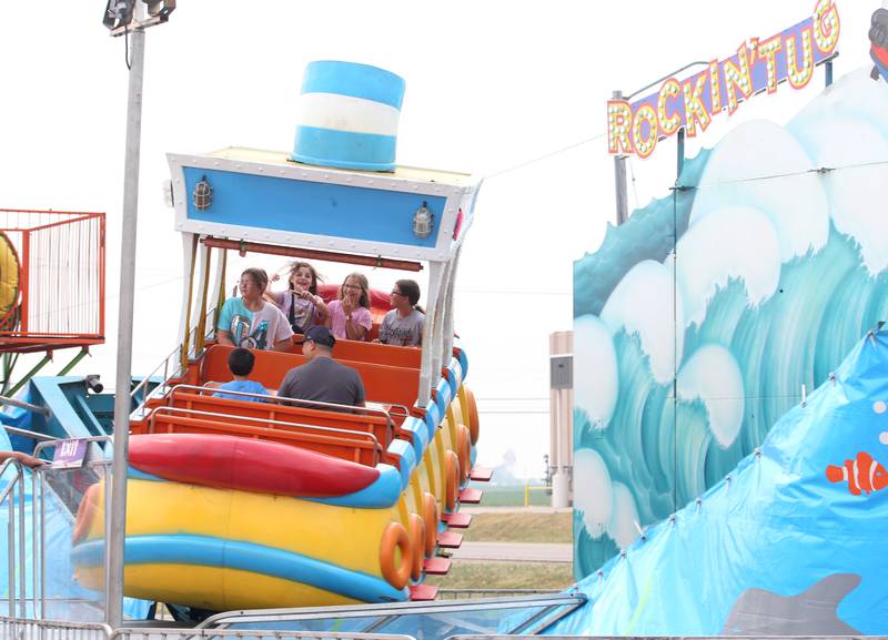 Kids ride the "Rockin' Tug" ride at the Peru Mall Carnival on Monday, June 26, 2023.