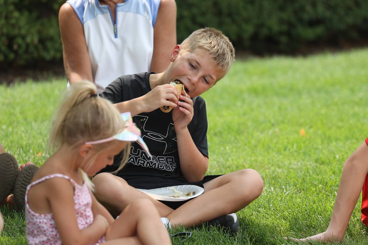 Matthew Bertola, 10-years old, bites into a taco at Taco Fest on Saturday, July 15th, 2023 in New Lenox.