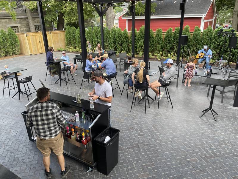 Patrons eat and listen to music on Saturday, Sept. 17, 2022, in downtown Richmond. Richmond celebrated its 150th anniversary over the weekend, with the celebration including the grand opening of The District, and a wine tasting.