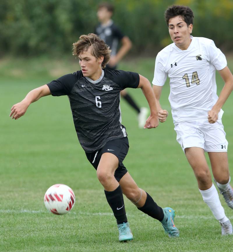 Kaneland's Noah McKittrick pushes the ball ahead of Sycamore's Javier Lopez during their game Wednesday, Sept. 6, 2023, at Kaneland High School in Maple Park.