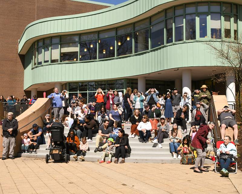 Community members gather around the Wheaton library on Monday April 8, 2024, for the solar eclipse watch party.