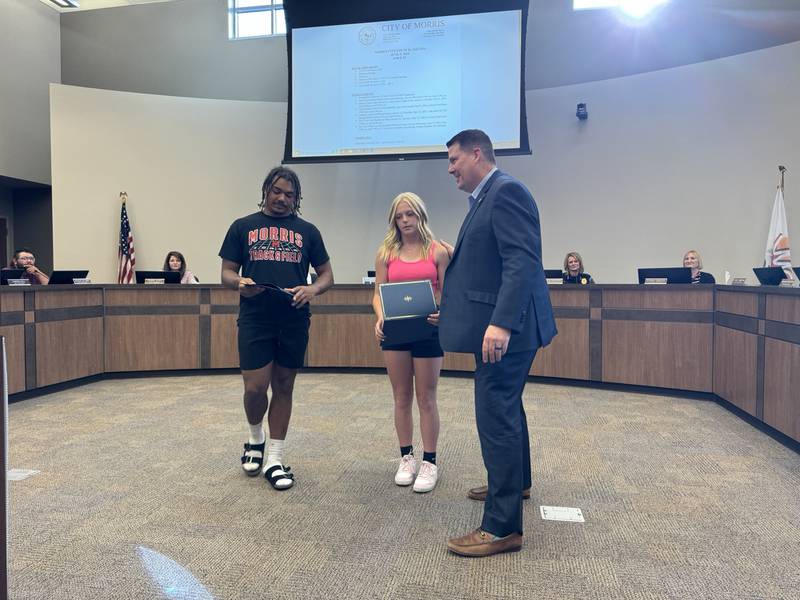 Mayor Chris Brown presents certificates to state-winners Malachi Congo (left) and Aniston Caputo.