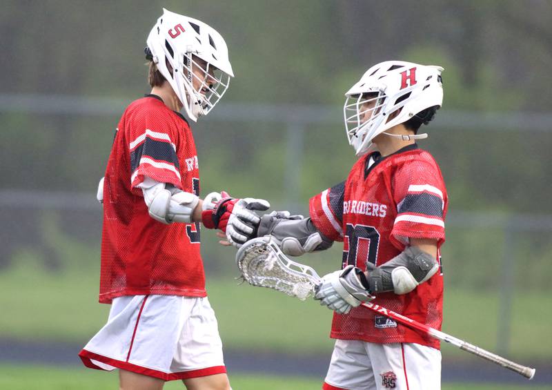 Huntley’s Nick Toman, left, and Cameron Abordo celebrate a Red Raider goal in varsity boys lacrosse at Prairie Ridge  High School in Crystal Lake on Thursday, May 1, 2025.