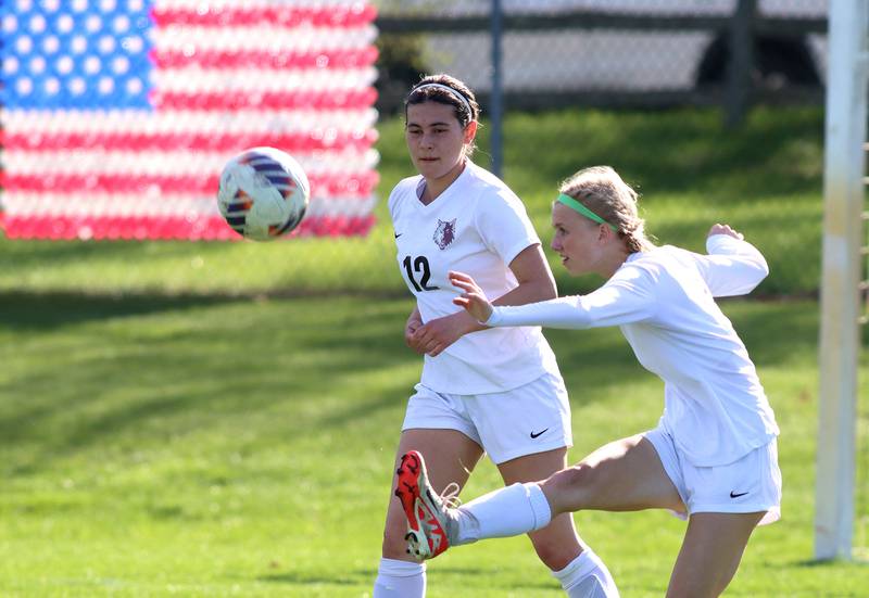 Prairie Ridge’s Carrie Sosnowski, front, clears the ball away as teammate Reaghan Deka keeps an eye on play in varsity girls soccer at Cary-Grove High School in Cary on Tuesday, April 29, 2025.