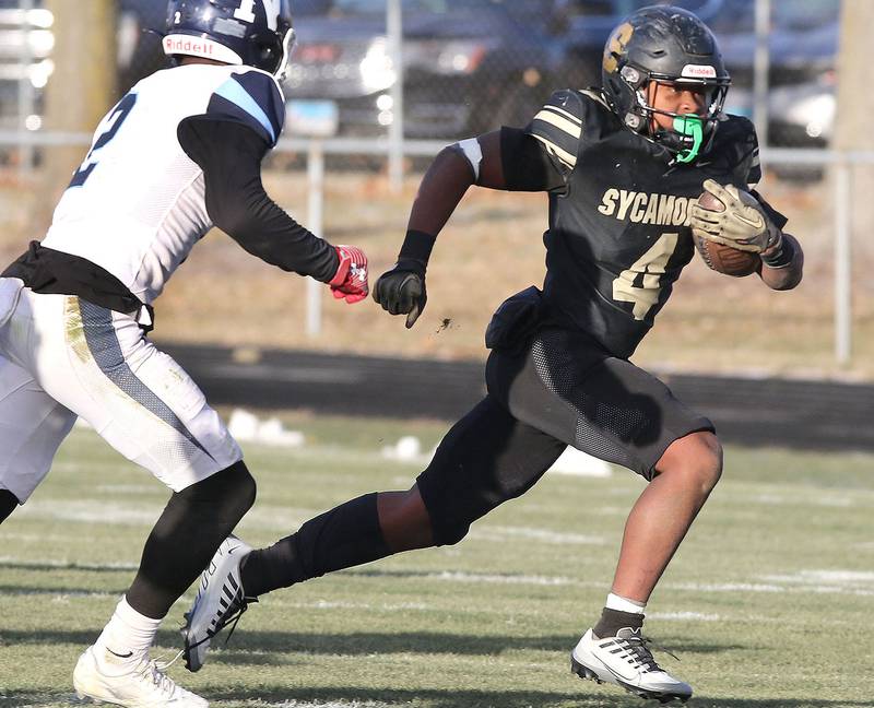 Sycamore's Tyler Curtis tries to get outside of Nazareth's Justin Taylor Saturday, Nov. 18, 2022, during the state semifinal game at Sycamore High School.