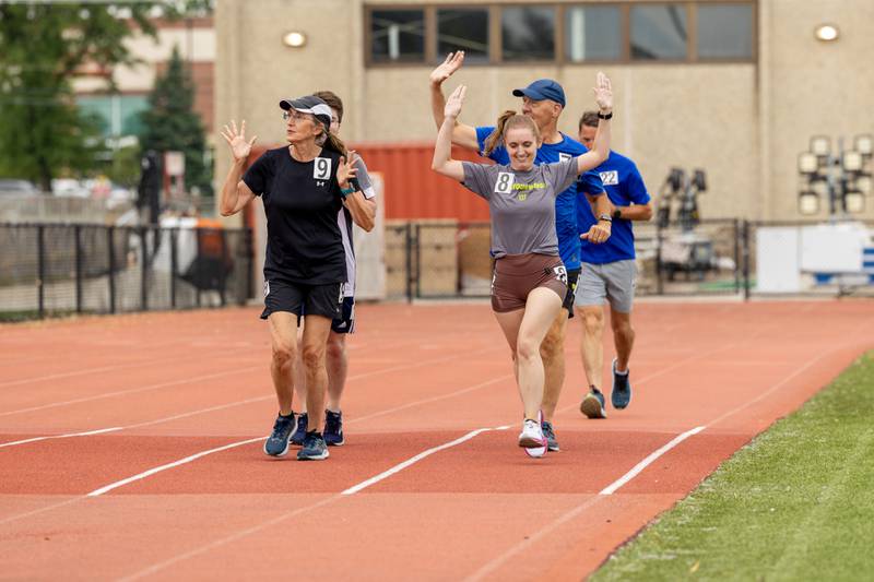 A group of runners wave to the crowd at Ben’s Memorial Mile, a community festival held every summer to raise money and awareness for mental health and suicide prevention in honor of Ben Silver, on Saturday, July 22, 2023.