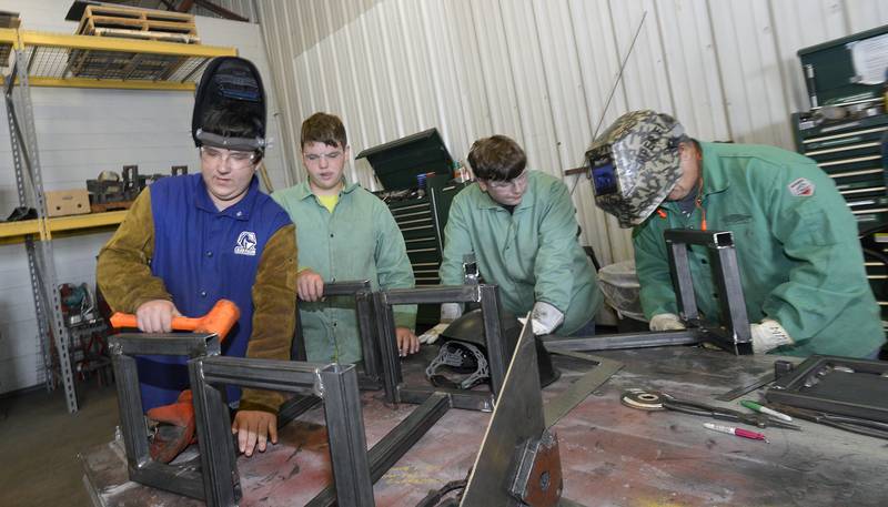 Students in the SPARK Junior Welding program work at finishing side tables Wednesday, June 28, 2023, during Illinois Valley's Community College's summer camps.