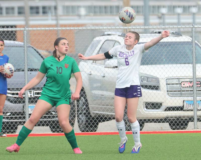 Rochelle's Paige Harris puts a headder on the ball as L-P's Kendal Bassett looks on on Wednesday, April 15, 2026 at the L-P Athletic Complex in La Salle.