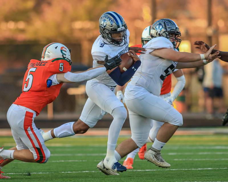 Oswego East's Tre Jones (9) takes off with the ball during varsity football game between Oswego East at Plainfield East.  Sept 8, 2022