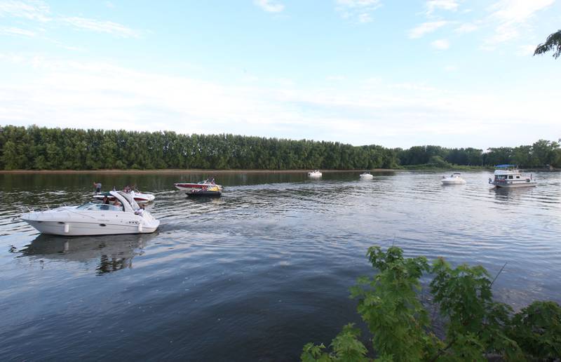 Pleasure boats make their way in front of Water Street along the Illinois River as they position themselves to watch the fireworks  on Wednesday, July 3, 2024 along Water Street in Peru.
