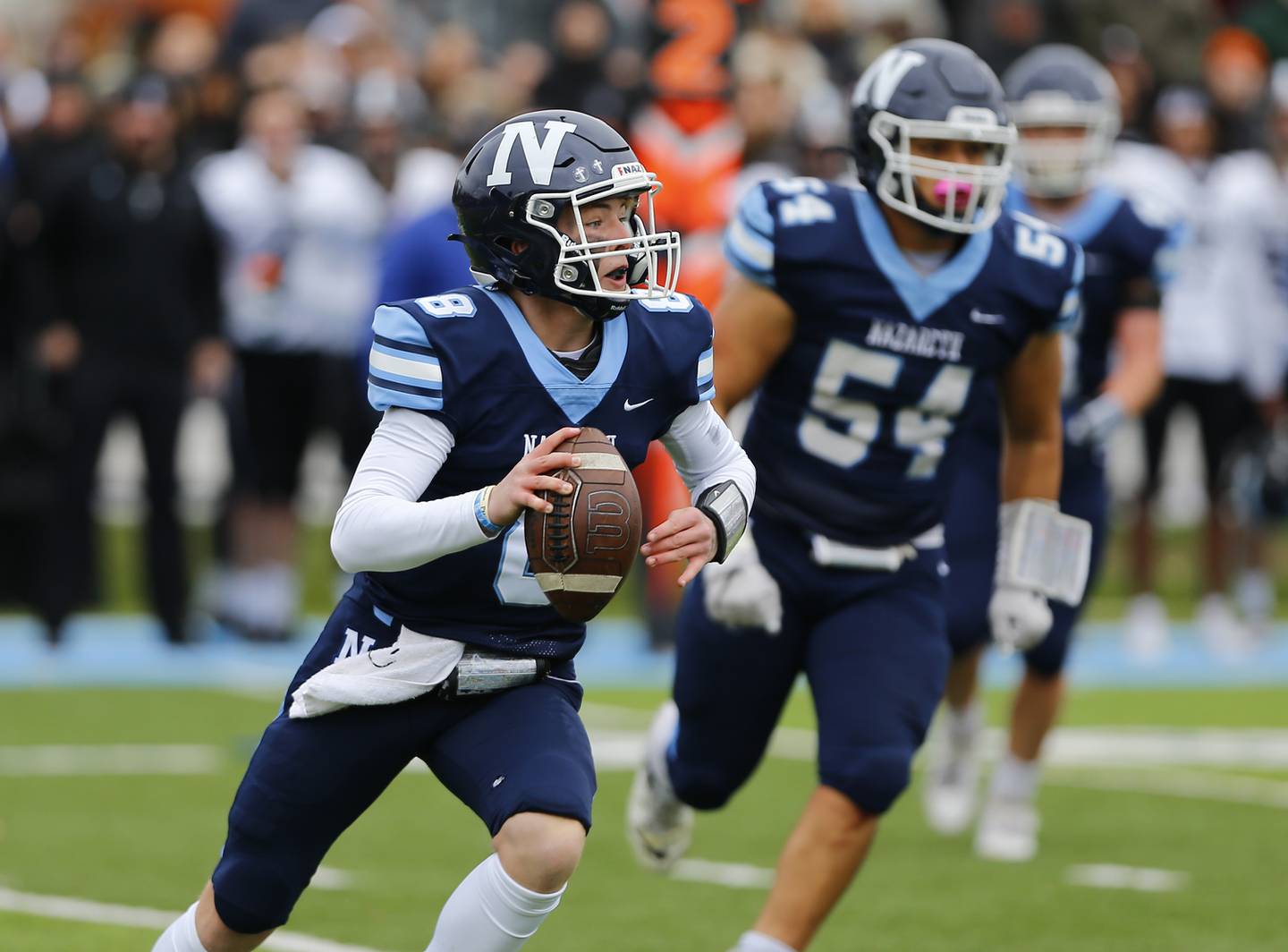 Nazareth's Logan Malachuk looks for a receiver during the IHSA Class 5A varsity football quarterfinal playoff game between Fenwick High School and Nazareth Academy on Saturday, November 13, 2021 in La Grange Park.