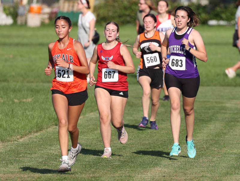 Rochelle’s Vivian Worthington (right) runs the girls varsity race Tuesday, Sept. 2, 2025, during the Sycamore Cross Country Invitational at Northern Illinois University in DeKalb.
